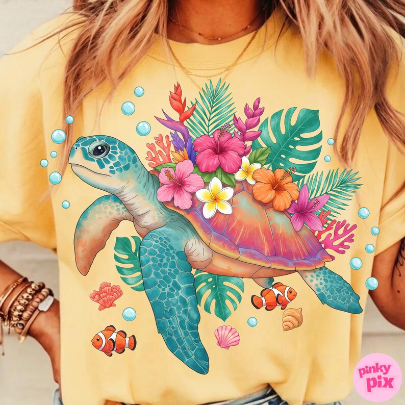 May include: Yellow t-shirt featuring a colorful sea turtle design. The turtle is adorned with tropical flowers and surrounded by bubbles, coral, and fish. The design includes pink, orange, blue, and green elements.
