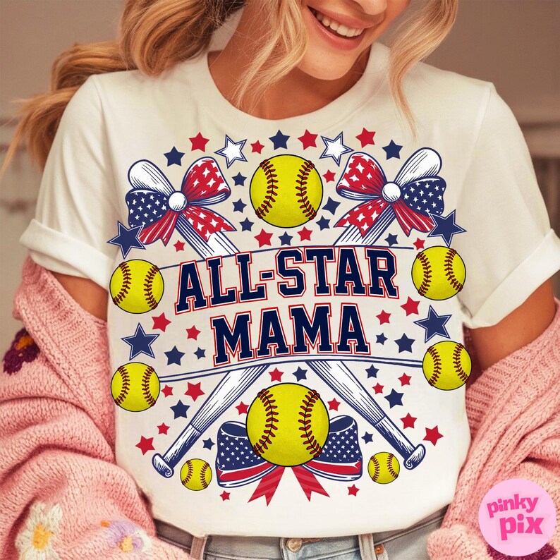 May include: White t-shirt with a softball-themed design. The shirt features the text "ALL-STAR MAMA" in navy blue and red, surrounded by softballs, baseball bats, stars, and patriotic bows in red, white, and blue.