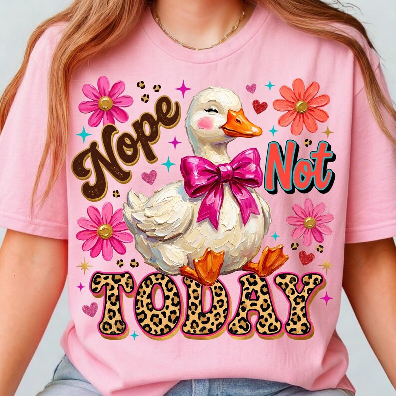 May include: Pink t-shirt featuring a cartoon duck with a pink bow, surrounded by flowers and the words "Nope Not Today". The duck has an orange beak and feet. The text "Today" has a leopard print design.