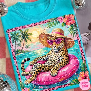 May include: Turquoise crew neck sweatshirt with a leopard wearing sunglasses and a straw hat, floating on a pink inflatable ring in the ocean. The design includes palm trees, flowers, and a tropical beach scene.