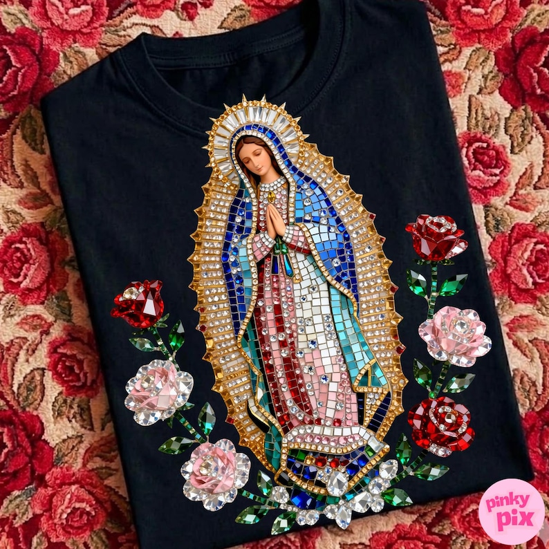 May include: Black t-shirt featuring a detailed mosaic-style image of the Virgin Mary, adorned with a gold halo and embellished with sparkling crystals. The design is accented with red and pink rose appliqu&eacute;s.