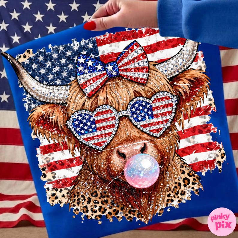 May include: Blue t-shirt featuring a Highland cow with patriotic embellishments. The cow wears heart-shaped sunglasses and a bow, both adorned with the American flag design. A bubble gum bubble adds a playful touch. The design incorporates leopard print and rhinestones.