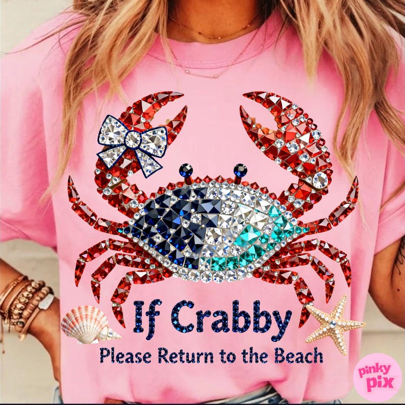 May include: Pink t-shirt featuring a bedazzled crab design with red, white, blue, and turquoise accents. The crab has a bow and the text "If Crabby, Please Return to the Beach". A seashell and starfish are also visible.