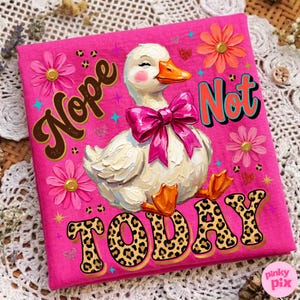 May include: A hot pink t-shirt featuring a whimsical illustration of a white duck with a pink bow, surrounded by flowers and the words "Nope Not Today" in playful fonts. The duck has orange feet and a beak.