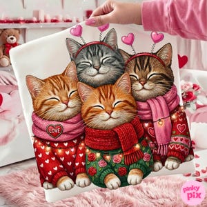 May include: A white pillowcase featuring a group of four smiling cats. The cats are wearing scarves and sweaters with heart and rose designs. Each cat has a headband with heart-shaped decorations.
