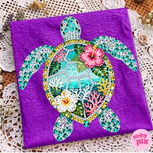 May include: A purple fabric with a bejeweled sea turtle design. The turtle features a turquoise shell, head, and flippers, with a detailed interior scene of a beach with coral and flowers. The design is embellished with sparkling gems.