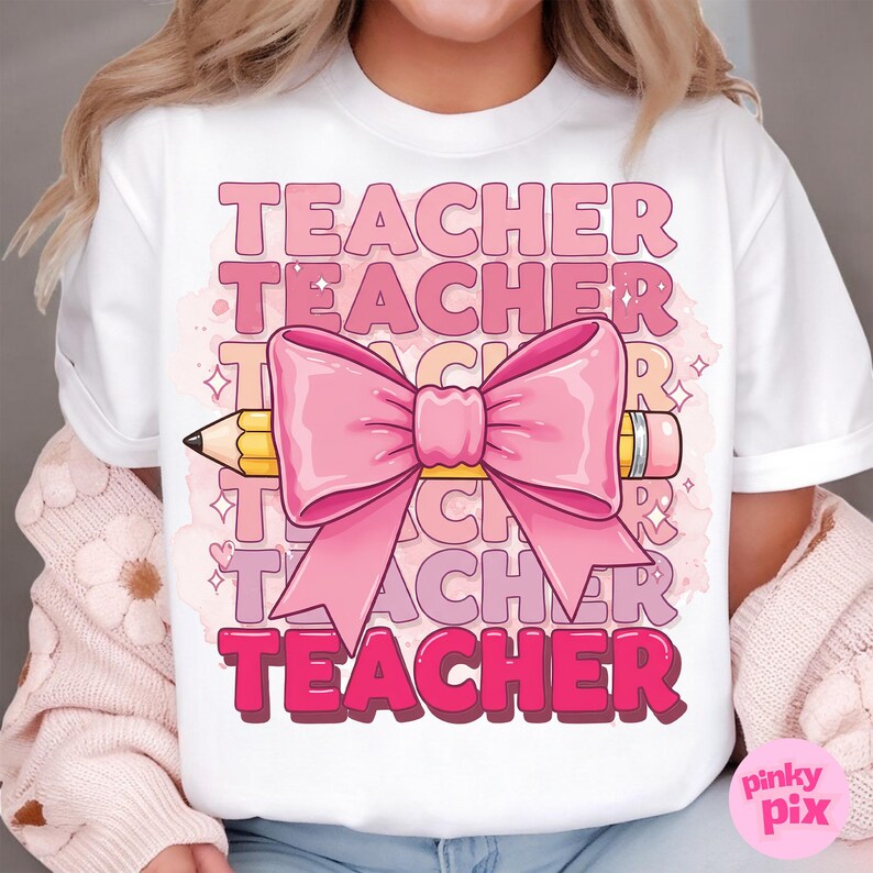 May include: White t-shirt with the word "TEACHER" repeated in pink, layered and overlapping. A pink bow with a yellow pencil tied through the centre is in the middle of the design.