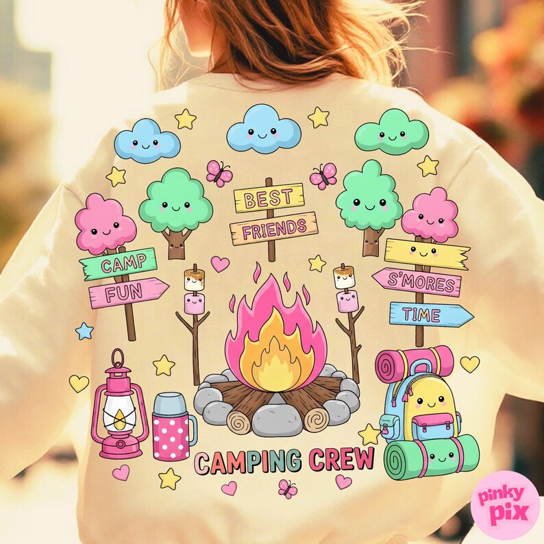 May include: Cream-colored sweatshirt with a colorful camping-themed graphic. The design includes cartoon trees, clouds, a campfire, marshmallows, and the words "CAMPING CREW", "CAMP FUN", "S'MORES TIME", and "BEST FRIENDS".