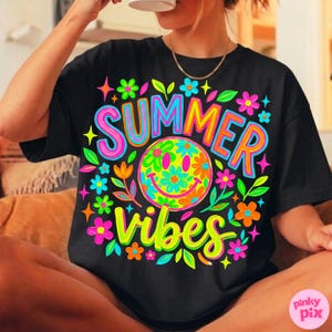 May include: Black t-shirt with a colorful "SUMMER VIBES" graphic. The design features a smiley face surrounded by flowers in shades of pink, blue, orange, and green. The text is outlined in bright colors.