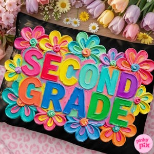 May include: A black pillow with the words "SECOND GRADE" in colorful, raised letters, surrounded by vibrant, textured flowers in shades of pink, yellow, blue, and orange. The pillow is a decorative item.