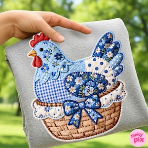 May include: A fabric applique of a patchwork chicken in a woven basket. The chicken is blue with floral and gingham patterns, a red comb and wattle, and a yellow beak. The basket has a blue bow with white floral accents.