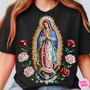 May include: Black t-shirt featuring a detailed mosaic-style image of a religious figure with hands clasped in prayer. The design includes a gold halo, blue and red robes, and is surrounded by red and pink roses with green leaves.