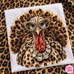 May include: A graphic print of a turkey with a leopard print pattern on its feathers, wearing cat-eye glasses with a leopard print frame and a large, clear crystal statement necklace. The turkey has a red wattle and a sharp, pointed beak.