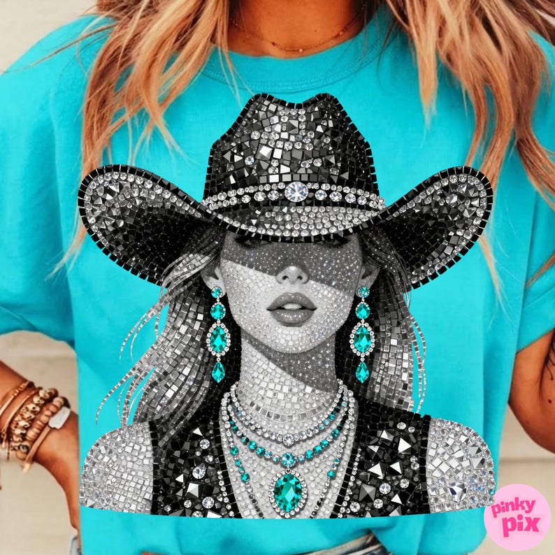 May include: A turquoise t-shirt featuring a mosaic-style illustration of a woman wearing a black cowboy hat and jewelry. The hat and jewelry are embellished with sparkling crystals. The woman's earrings and necklace feature turquoise gemstones.