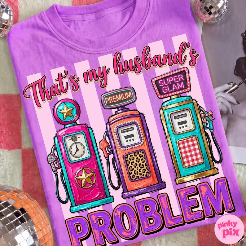 May include: A purple t-shirt with a graphic of three vintage gas pumps in pink, orange, and teal. The text "That's my husband's PROBLEM" is in pink and purple. The gas pumps have star and leopard print details.