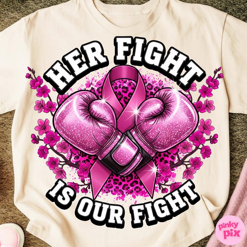 May include: Cream-colored t-shirt featuring a design with the text "HER FIGHT IS OUR FIGHT". The design includes pink boxing gloves, a pink ribbon, and pink floral accents. The gloves have a glittery texture, and the background has a leopard print.