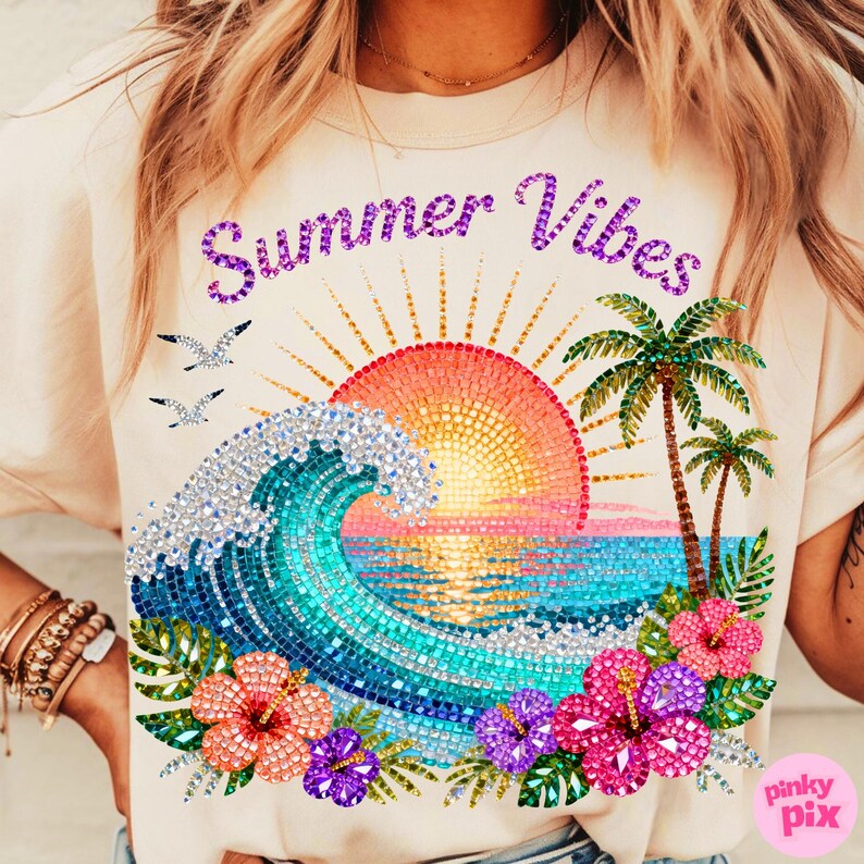 May include: A light beige t-shirt with a colorful summer design. The design features a mosaic-style sunset, ocean wave, palm trees, and hibiscus flowers. The words "Summer Vibes" are written across the top in purple.