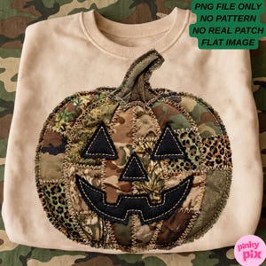 May include: A beige crewneck sweatshirt featuring a large pumpkin graphic made of patchwork fabric in various camouflage and leopard print patterns. The pumpkin has black felt eyes, a nose, and a mouth with visible decorative stitching.