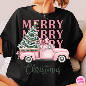 May include: Black t-shirt featuring a pink pickup truck carrying a Christmas tree with a large pink bow. The words "MERRY MERRY CHRISTMAS" are printed in pink and green.