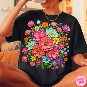 May include: Black t-shirt featuring a vibrant floral design. The design showcases a bouquet of colorful flowers in shades of pink, orange, yellow, blue, and purple. The flowers appear to have a textured, three-dimensional effect.