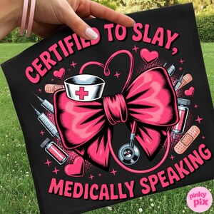 May include: Black t-shirt with a pink bow, nurse's hat, stethoscope, syringes, and the text "CERTIFIED TO SLAY, MEDICALLY SPEAKING." The design includes hearts and medical elements.