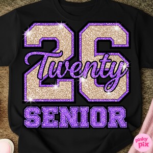 May include: Black t-shirt with a glittery gold and purple graphic. The design features the number "26", the word "Twenty", and the word "Senior" in a collegiate style font. The shirt is a classic crew neck.