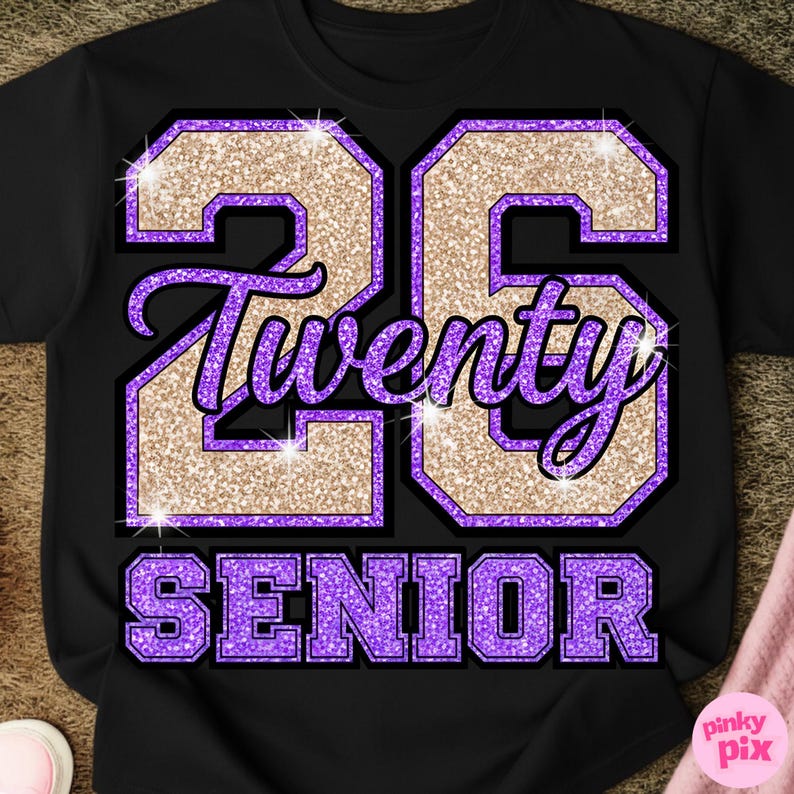 May include: Black t-shirt with a glittery gold and purple graphic. The design features the number "26", the word "Twenty", and the word "Senior" in a collegiate style font. The shirt is a classic crew neck.