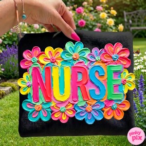 May include: Black square with the word "NURSE" in vibrant, multi-colored 3D lettering, surrounded by colorful flower embellishments. The flowers are in shades of pink, yellow, blue, and orange. The background is a garden setting.