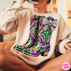 May include: A pair of decorative cowboy boots with a mosaic design. The boots feature a vibrant color scheme of green, purple, and gold, embellished with sparkling rhinestones. A large jeweled bow adorns the top of one boot.