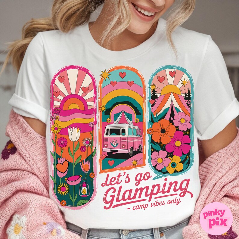 May include: White t-shirt with a retro-style graphic design featuring a pink camper van, a rainbow, a sunset, and flowers. The text "Let's go Glamping - camp vibes only." is printed on the shirt.