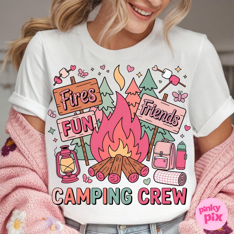 May include: White t-shirt with a colorful camping graphic. The design includes a campfire, signs that read "Fires, Fun, Friends", and camping gear. The words "Camping Crew" are printed at the bottom.