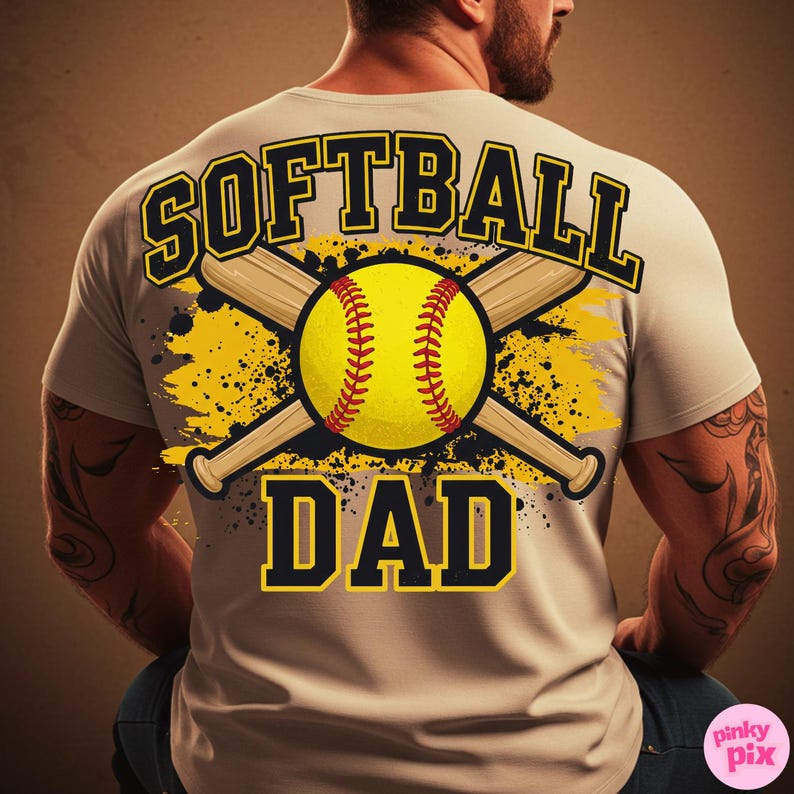 May include: A light gray t-shirt with the words "SOFTBALL DAD" in black and yellow lettering. The design includes a yellow softball with red stitching, crossed baseball bats, and yellow splatter accents.