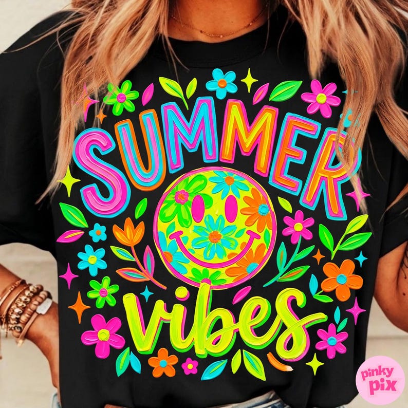 May include: Black t-shirt with a colorful graphic design. The design features the words "SUMMER VIBES" in bright pink, yellow, and green, along with a smiley face surrounded by flowers. The overall theme is summer and happiness.