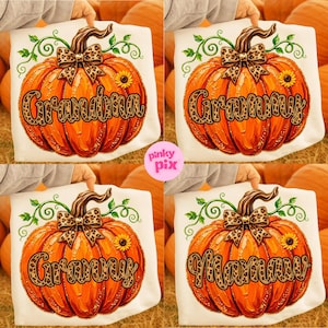 May include: A white t-shirt featuring a large orange pumpkin graphic with green vines, a leopard print bow, and a small sunflower. The pumpkin is overlaid with the text Grandma, Grammy, or Mamaw in a leopard print font style.