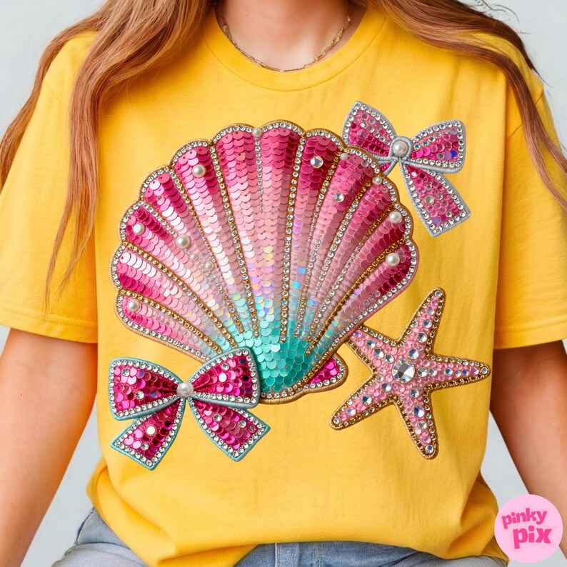 May include: Yellow t-shirt featuring a sequined seashell design in pink, teal, and gold, adorned with pearl accents and two sequined bows. A sequined starfish adds to the nautical theme. The shirt has a relaxed fit.