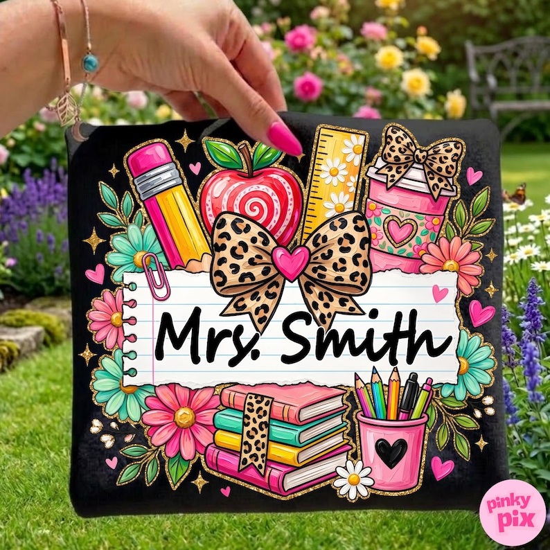 May include: Black decorative pillow with a colorful teacher-themed design. Features a pencil, apple, ruler, coffee cup, books, and pencils. The text "Mrs. Smith" is displayed on a lined paper background, surrounded by flowers and hearts.