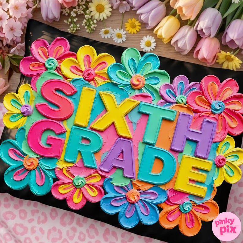 May include: A colorful, floral-themed cake with the words "SIXTH GRADE" in bright, bold letters. The cake is decorated with vibrant flowers in shades of pink, yellow, blue, and orange, set against a black background.