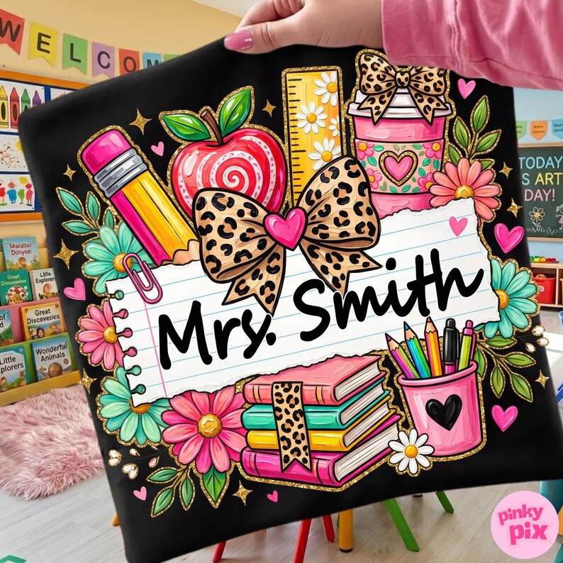 May include: Black teacher-themed design featuring a pencil, apple, ruler, coffee cup, books, and pencils. The design includes a leopard print bow and the name "Mrs. Smith" on a lined paper background. Floral accents and hearts complete the design.