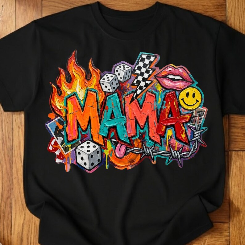 May include: Black t-shirt with a colorful graphic design. The design features the word "MAMA" in vibrant orange, teal, and red, surrounded by flames, dice, a lightning bolt, lips, a smiley face, and barbed wire.
