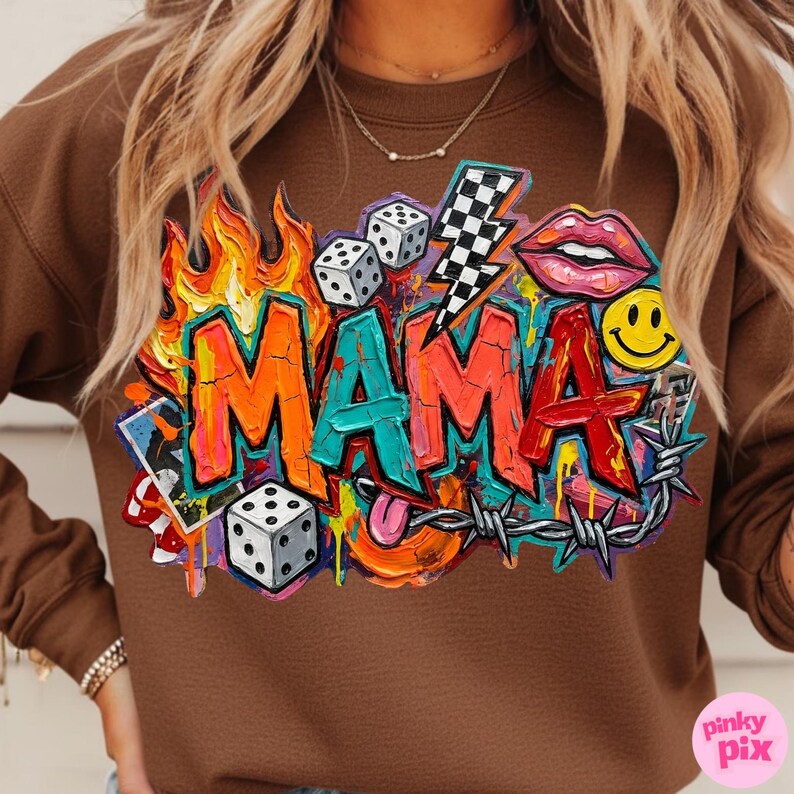 May include: Brown sweatshirt with a colorful graphic that says "MAMA". The design includes flames, dice, a lightning bolt, lips, a smiley face, and barbed wire. The sweatshirt is a solid brown color.