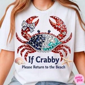 May include: White t-shirt featuring a crab design with red, blue, and clear crystal accents. The crab has a bow and the text reads "If Crabby Please Return to the Beach". A seashell and starfish are also featured.