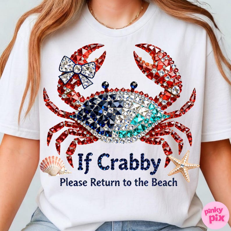 May include: White t-shirt featuring a crab design with red, blue, and clear crystal accents. The crab has a bow and the text reads "If Crabby Please Return to the Beach". A seashell and starfish are also featured.