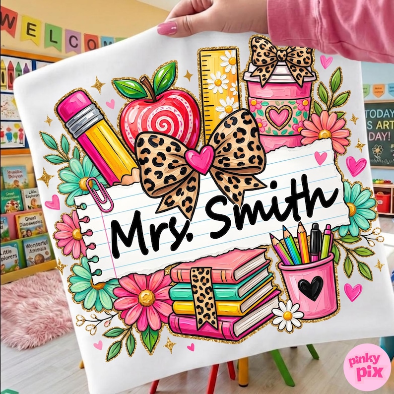 May include: A white pillowcase featuring a colorful teacher-themed design. The design includes a pencil, apple, ruler, coffee cup, books, and pencils. The name "Mrs. Smith" is written on a lined paper. Floral and heart accents complete the design.
