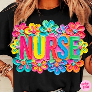 May include: Black t-shirt with the word "NURSE" in colorful, 3D-style letters, surrounded by vibrant, multi-colored flowers. The flowers include shades of pink, yellow, blue, and orange, creating a cheerful design.