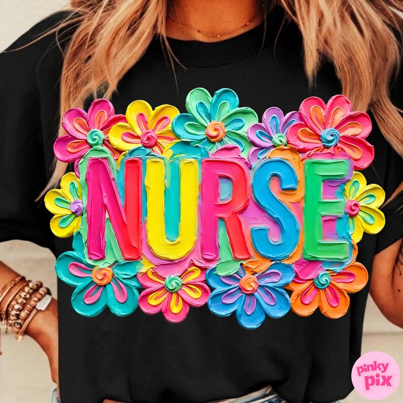 May include: Black t-shirt with the word "NURSE" in colorful, 3D-style letters, surrounded by vibrant, multi-colored flowers. The flowers include shades of pink, yellow, blue, and orange, creating a cheerful design.
