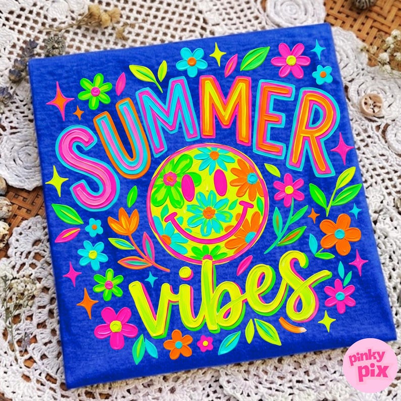 May include: A blue graphic t-shirt with the words "SUMMER VIBES" in bright neon colors. The design includes a smiley face surrounded by flowers and leaves. The text and graphics are outlined in various colors, creating a vibrant and cheerful design.