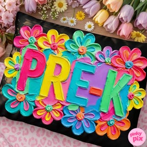 May include: A black pillow with the word "PRE-K" in colorful, textured letters, surrounded by vibrant, multi-colored flowers. The flowers have shades of pink, yellow, blue, and orange. The pillow is decorated with a floral design.