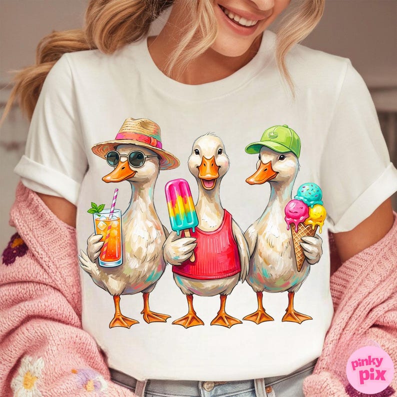May include: White t-shirt featuring a whimsical illustration of three ducks enjoying summer treats. One duck wears a straw hat and sunglasses, holding a drink. Another has a popsicle, and the third holds an ice cream cone. The ducks are wearing a red tank top and a green cap.