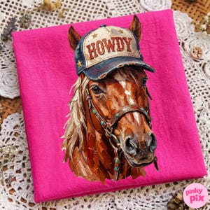 May include: A vibrant pink square fabric featuring a detailed illustration of a horse wearing a distressed baseball cap. The cap is blue and cream with the word "HOWDY" and star accents. The horse has a brown coat and a bridle.