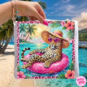 May include: A decorative beach towel featuring a leopard wearing sunglasses and a straw hat, floating on a pink inflatable ring in tropical waters. The towel has a pink border with floral and leopard print accents, and a tropical beach scene.
